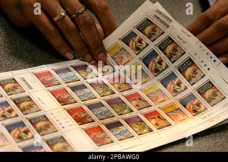 An employee of Britain's Royal Mail counts sheets of Harry Potter stamps  ready to be put on sale for the first time at Trafalgar Square Post Office  in London, Tuesday, July 17, 2007. Harry Potter stamps have already broken  records to be the most anticipated