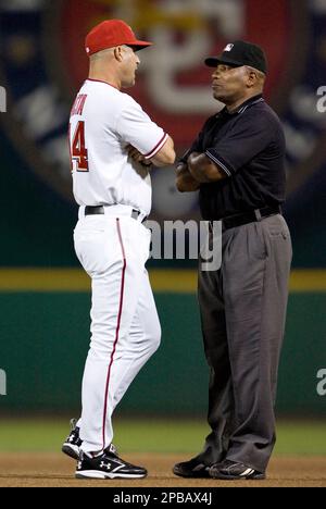 Philadelphia Phillies runner Chase Utley (L) questions his being held at  third base on a ground rule double with home plate umpire Laz Diaz during  the first inning at Coors Field in