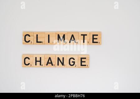 Wooden title spelling the words climated change isolated on a white background Stock Photo