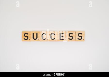 Wooden title spelling the word success isolated on a white background Stock Photo
