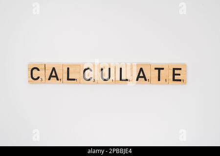 Wooden title spelling the word calculate isolated on a white background Stock Photo