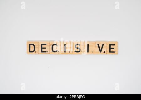 Wooden title spelling the word decisive isolated on a white background Stock Photo