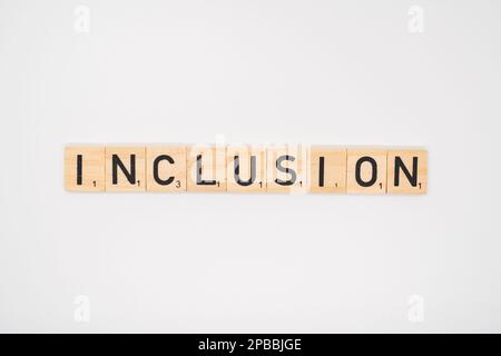 Wooden title spelling the word iinclusion isolated on a white background Stock Photo