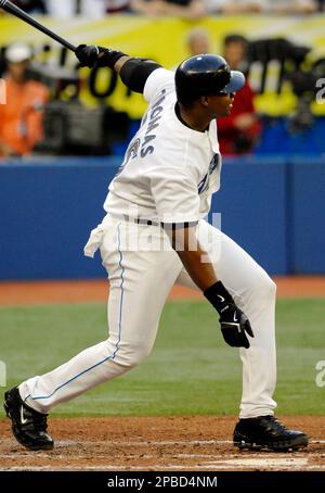 Toronto Blue Jays' Frank Thomas, left, reacts as he is held back by coach  Ernie Whitt after being tossed from the game by home plate umpire Bill  Miller, right, during fourth inning