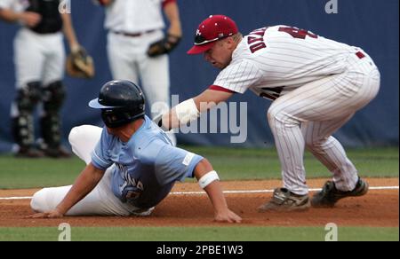 North Carolina's Kyle Seager, left, and Mike McKee (38) celebrate their 9-3  win over East Carolina during a NCAA super regional college baseball  championship game in Chapel Hill, N.C., Sunday, June 7