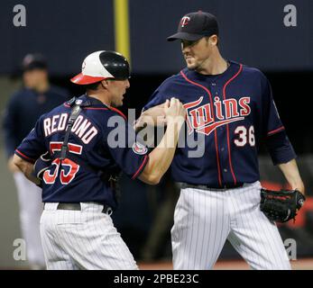Minnesota Twins catcher Joe Mauer, right, and Justin Morneau congratulate  closer Joe Nathan, who made the last out against the Detroit Tigers at the  Metrodome in Minneapolis, Minnesota, Thursday, May 14, 2009.