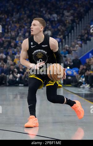 Golden State Warriors guard Donte DiVincenzo (0) handles the ball during  the second half of an NBA basketball game against the Minnesota  Timberwolves, Wednesday, Feb. 1, 2023, in Minneapolis. (AP Photo/Abbie Parr