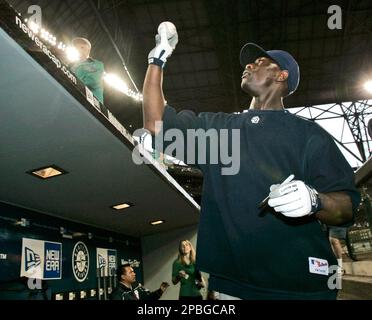 Seattle Mariners former second baseman Bret Boone, left, and former  outfielder Mike Cameron, right, stand in the dugout before throwing out  ceremonial first pitches before a baseball game between the Mariners and