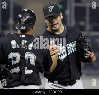 Florida Marlins' Miguel Olivo, right, celebrates with Aaron Boone