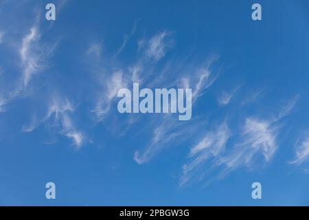 Clouds and moon against a beautiful blue sky Stock Photo