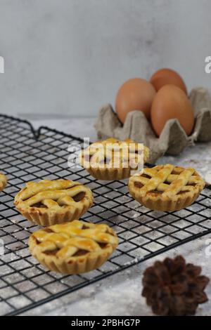 Small Apple Tart Served On A White Plate With Custard And Cinnamon 