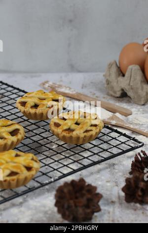 Small Apple Tart Served On A White Plate With Custard And Cinnamon 