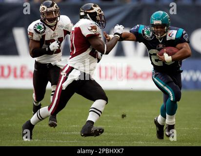 Hamburg's Running Back Quentin Griffin, right, is tackled by Rhein Fire's  Jermaine Hardy, left, during the European football league, NFL Europe,  match between Hamburg Sea Devils and Rhein Fire at the AOL