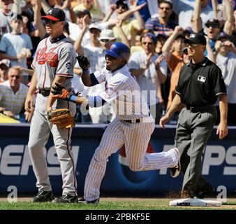 New York Mets' Jose Reyes grabs Atlanta Braves third baseman Chipper Jones,  left, after hitting a three-run triple in the sixth inning of the Mets' 9-6  loss to the Braves in their baseball game at Shea Stadium in New York,  Sunday, April 22, 2007. Third