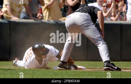 Baltimore Orioles outfielders, from left to right, Felix Pie, Nick Markakis  and Adam Jones celebrate after defeating the Texas Rangers 5-0 in the first  baseball game of a doubleheader on Saturday, April