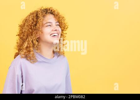 A happy woman with curly hair standing Stock Photo