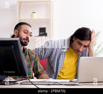 The two it specialists working in the office Stock Photo