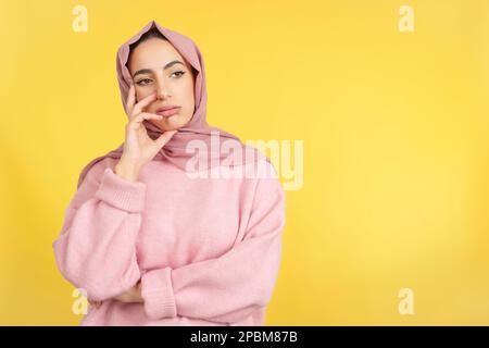 Bored muslim woman standing and looking away Stock Photo