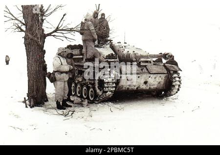 World War Two B&W photo German Heavy Assault Gun stands ready in the Winter Snow of 1943/44. The symbol on the Sturmgeschuetz may be from either the 3rd Panzer Division or the 3rd SS Panzer Division Stock Photo