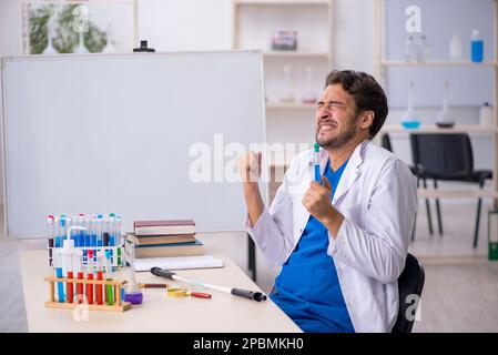 Young chemist working at the lab Stock Photo