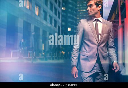 Metro man on the move. a handsome businessman in a suit walking through the city at night. Stock Photo