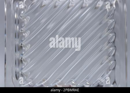 Defocused abstract macro texture background view of a beautiful modern lead crystal glass surface with shimmering diagonal lines Stock Photo
