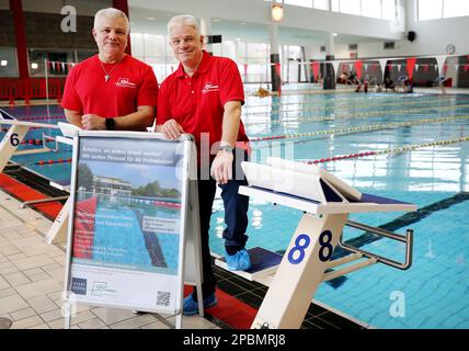 Essen, Germany. 09th Mar, 2023. Swimming supervisor Enrique Gonzalez (l) and lifeguard instructor Michael Katz are looking for lifeguards for the summer with a poster 'Working where others go on vacation - We're looking for staff for the outdoor pool season.' If the required 50 lifeguards are missing in the summer, many outdoor pools could remain closed. (to dpa: 'When the lifeguard is missing - outdoor pools are looking for staff for the summer') Credit: Roland Weihrauch/dpa/Alamy Live News Stock Photo