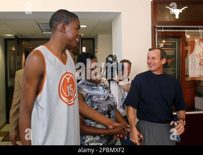 Texas basketball player Kevin Durant, left, walks with his mother, Wanda  Pratt, center and Texas coach