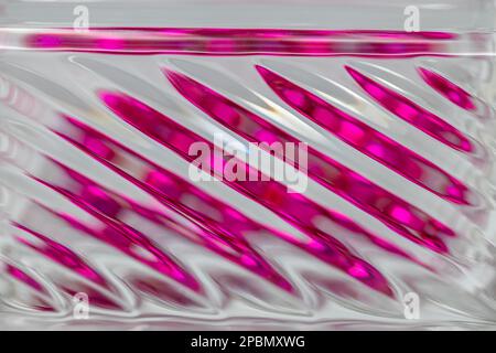 Defocused abstract macro texture background view of a beautiful modern lead crystal glass surface with shimmering diagonal lines Stock Photo