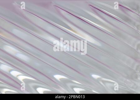 Defocused abstract macro texture background view of a beautiful modern lead crystal glass surface with shimmering diagonal lines Stock Photo