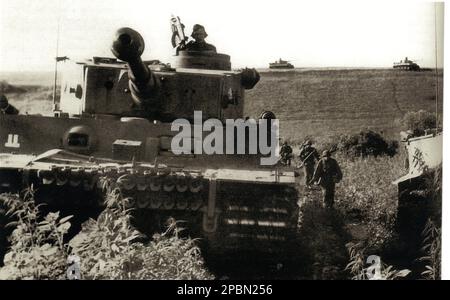 World War Two B&W photo German Tiger 1 Tank and Grenadiers advances during the Battle of Kursk. The Tiger has the tactical insignia of the 2nd SS Panzer Division 'Das Reich' Stock Photo