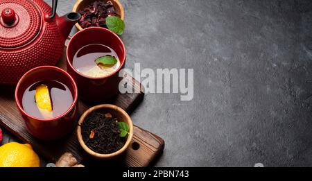 Tea with lemon and mint and teapot on wooden board. With copy space Stock Photo