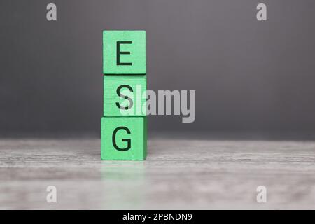 ESG Concepts on Environment, Society and Governance sustainable corporate development Wooden cube with green ESG abbreviation. Copy space for text Stock Photo