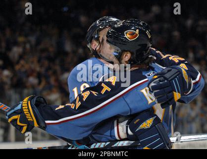 Atlanta Thrashers' Alexei Zhitnik, right, of Ukraine, celebrates with  teammate Marian Hossa, of Slovakia, after scoring the winning goal in  overtime of an NHL hockey game against the Tampa Bay Lightning in
