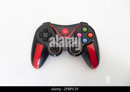 Modern black and red gamepad joystick on white background. Top view Stock Photo