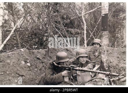 World War Two B&W photo German Soldiers of the 6th SS Mountain Division Nord use a Light MG . The 6th SS Mountain Division was initially a very poorly performing unit but after training under Finnish guidance became a more than competent Division . Stock Photo