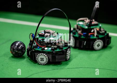 Berlin, Germany. 12th Mar, 2023. Two robots compete for the ball at the Soccer qualifying tournament of RoboCup Junior. 164 students from 14 schools and institutions are taking part in RoboCup Junior in Germany. Credit: Fabian Sommer/dpa/Alamy Live News Stock Photo