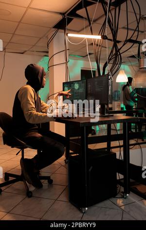 Cyber security, encryption specialist fixing database cyberattack, developer coding antivirus program. African american coder programming app, cybersecurity technology, computer system protection Stock Photo