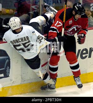 New Jersey Devils Mike Rupp right checks Pittsburgh Penguins Sergei Gonchar of Russia during third period NHL hockey Wednesday night March 14 2007 in East Rutherford N.J. The Penguins won 3 0. AP