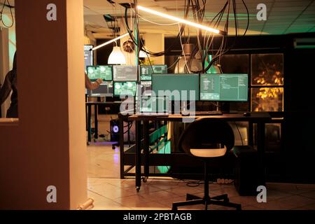Online criminals hacking database system with virus, stealing personal information with computer malware. Anonymous hackers running malicious software and accessing security server. Stock Photo