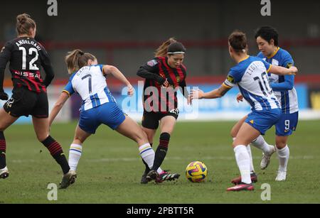 Crawley, UK. 12th Mar, 2023. Man City's Yui Hasegawa(Centre) is challenged by Brighton's Veatriki Sarri (2nd L) during the FA Women's Super League match between Brighton & Hove Albion and Manchester City at the Broadfield Stadium. Credit: James Boardman/Alamy Live News Stock Photo