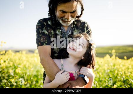 Uncle & Niece Embrace in Flower Field in San Diego Stock Photo