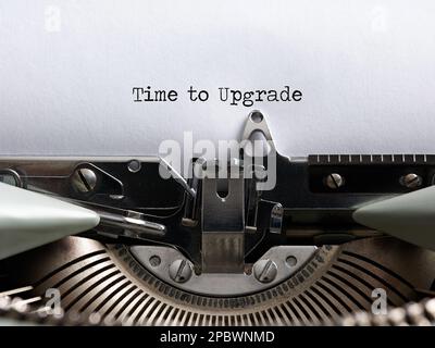 The word time to upgrade written with a vintage typewriter. Technology update concept. Stock Photo