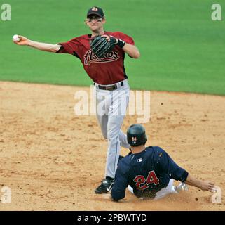 The ball sails past the outstretched glove of New York Mets third baseman David  Wright as Houston Astros Adam Everett, right, slides safely in after  stealing second and taking third on an