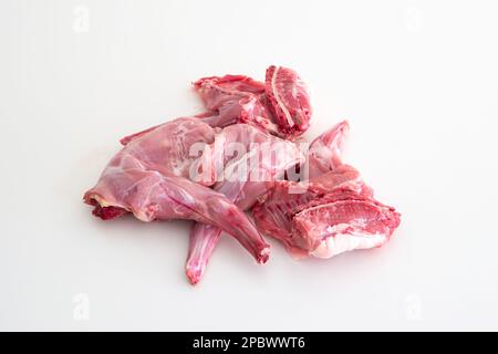 Uncooked raw rabbit or hare legs. Close up top view studio shot, no people. Stock Photo