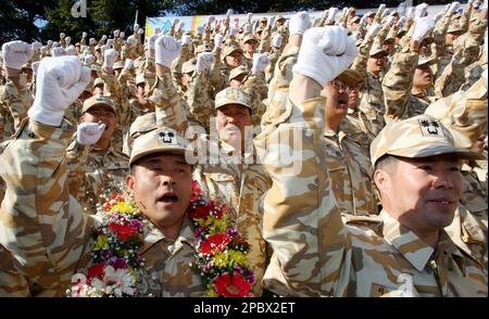 South Korean Army soldiers who will be dispatched to Iraq shout slogans  during a farewell ceremony at a military base in Gwangju