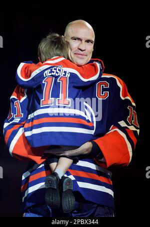 Hockey great Mark Messier hold his son, Douglas Paul Messier, during his  jersey retirement ceremony prior to the game between the Edmonton Oilers  and Phoenix Coyotes in Edmonton, Tuesday, Feb. 27, 2007. (