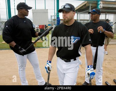 Toronto Blue Jays' Frank Thomas, left, reacts as he is held back by coach  Ernie Whitt after being tossed from the game by home plate umpire Bill  Miller, right, during fourth inning