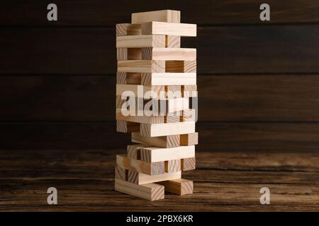 Jenga tower made of wooden blocks on table Stock Photo