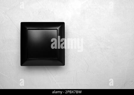 Black light switch on grey background, top view. Space for text Stock Photo